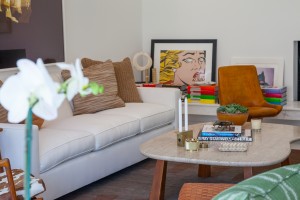 In the living room, designed by Trip Haenisch, custom furnishings from THA and pieces from Haenisch’s own collection, encircle a coffee table from Hollywood at Home.