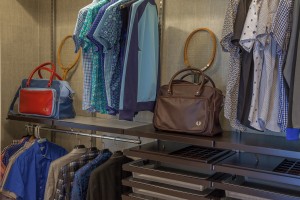 The master bedroom suite, designed by Christopher Kennedy, includes this enormous wrap around walk in closet with fittings from Elfa by The Container Store.